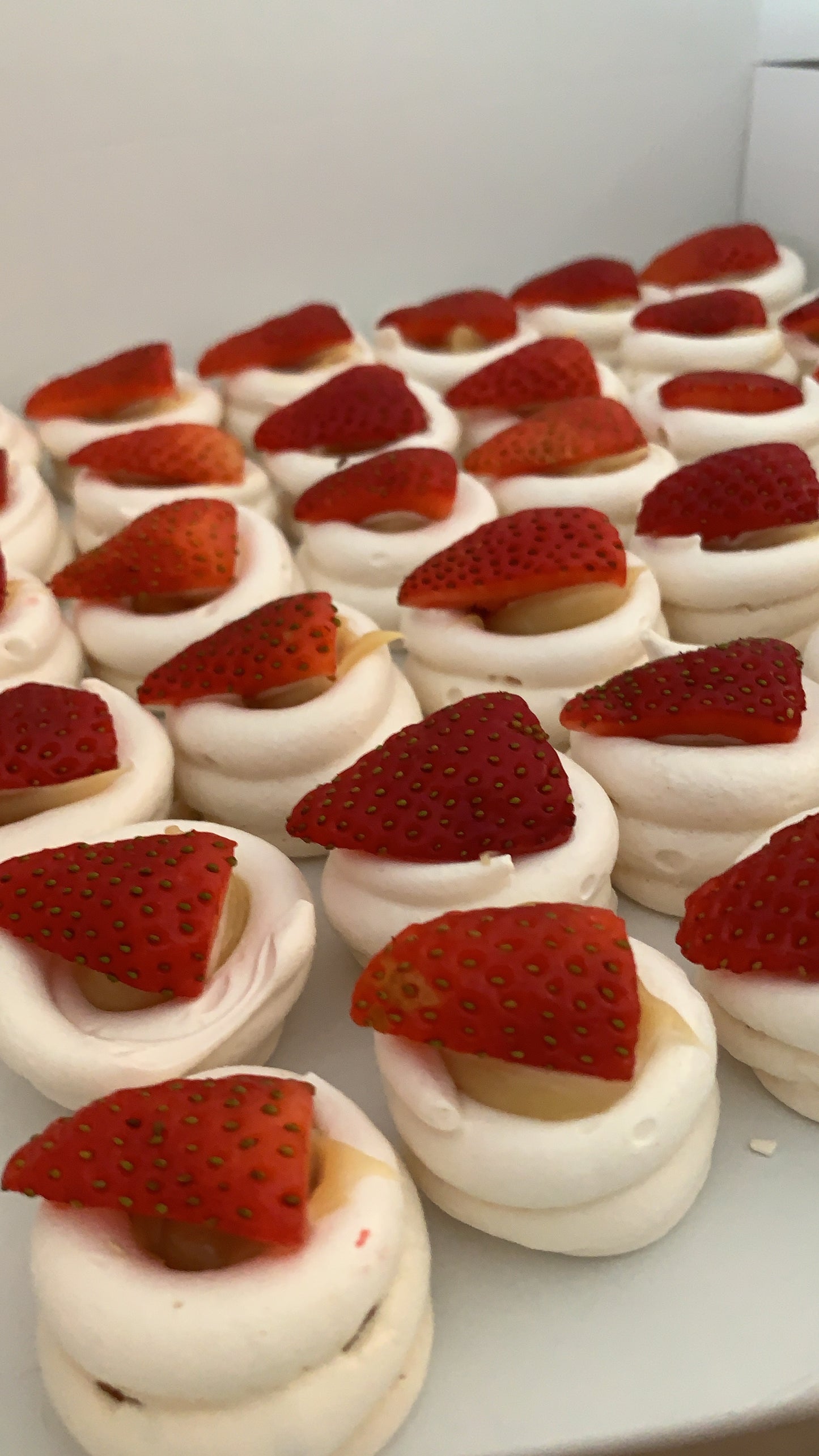 Dessert with meringue and strawberries on a white plate