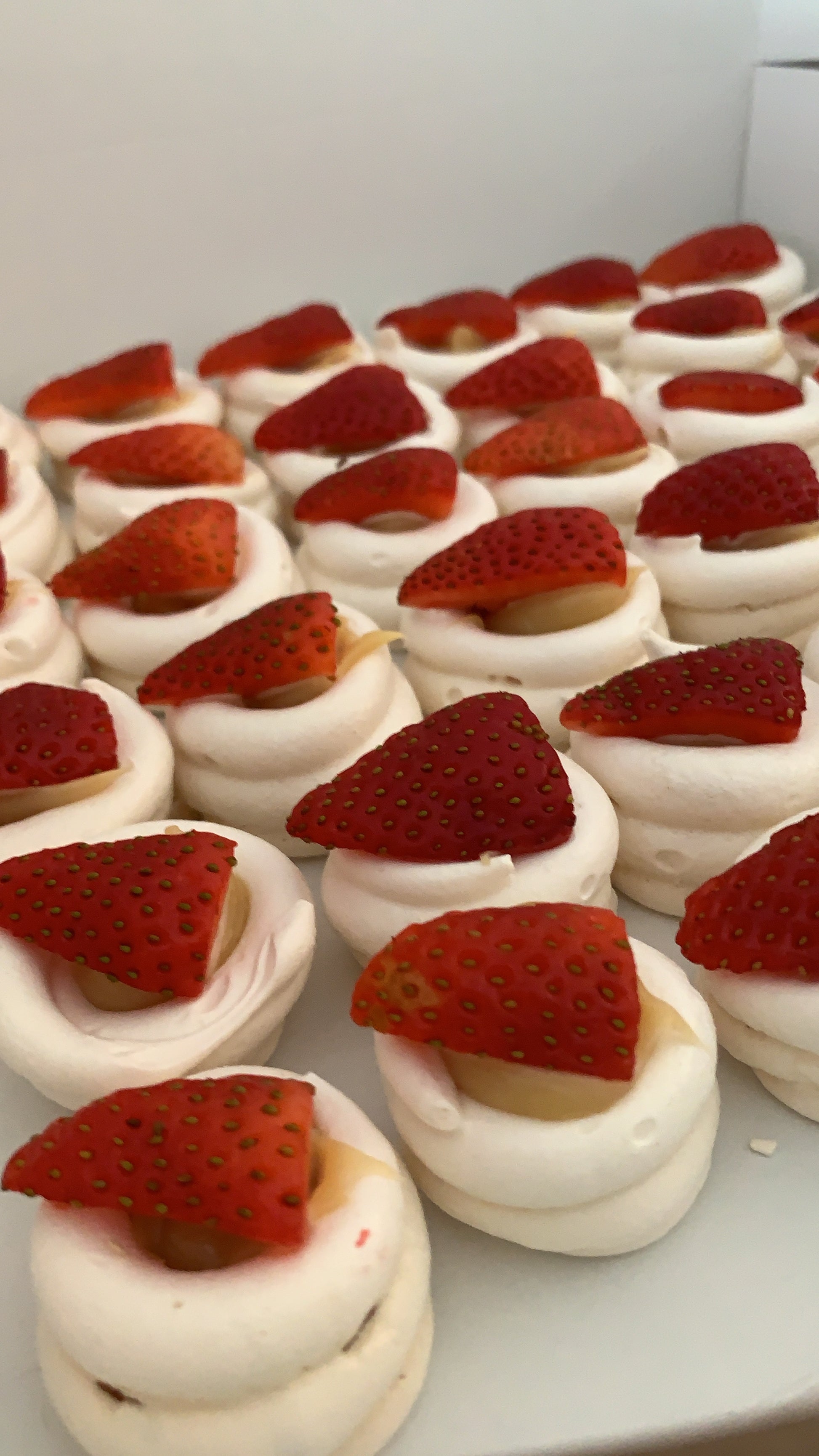 Dessert with meringue and strawberries on a white plate